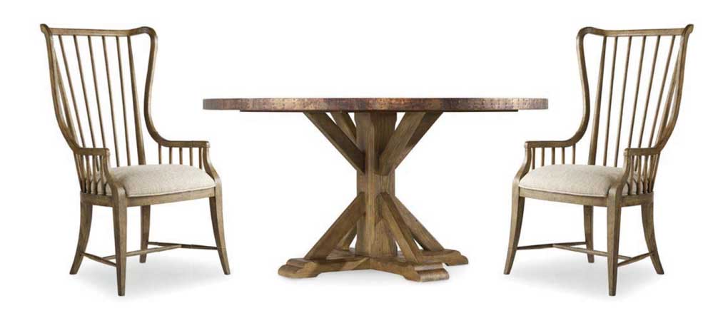 Farmhouse pedestal table and two high-back dining chairs. 