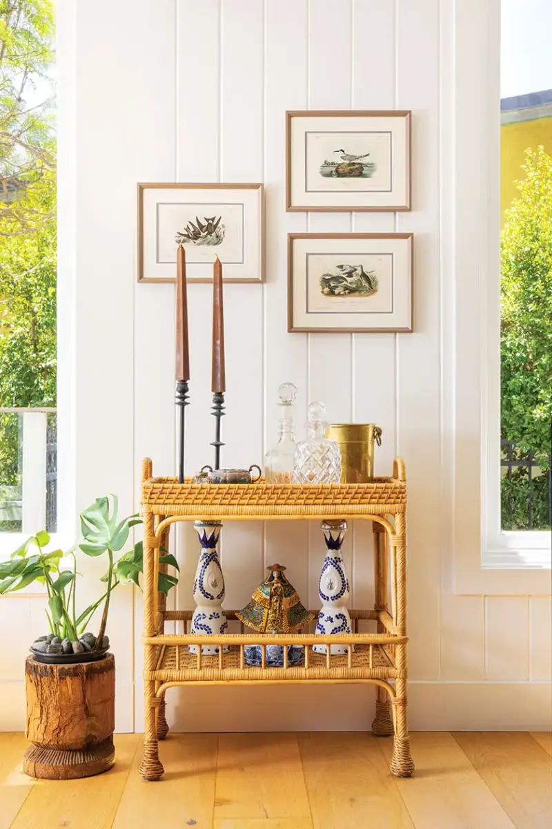 vintage style animal illustrations and rattan side table in 1940s beach cottage