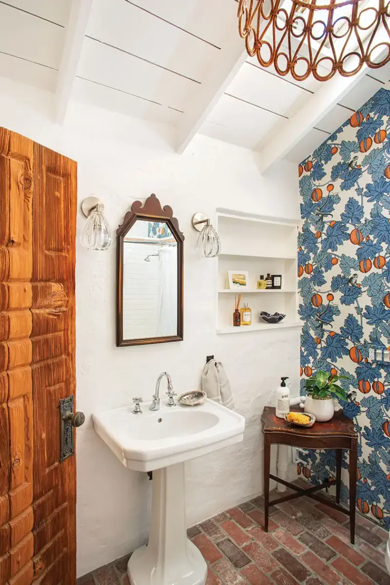 botanical wallpaper and rattan chandelier in 1940s beach cottage