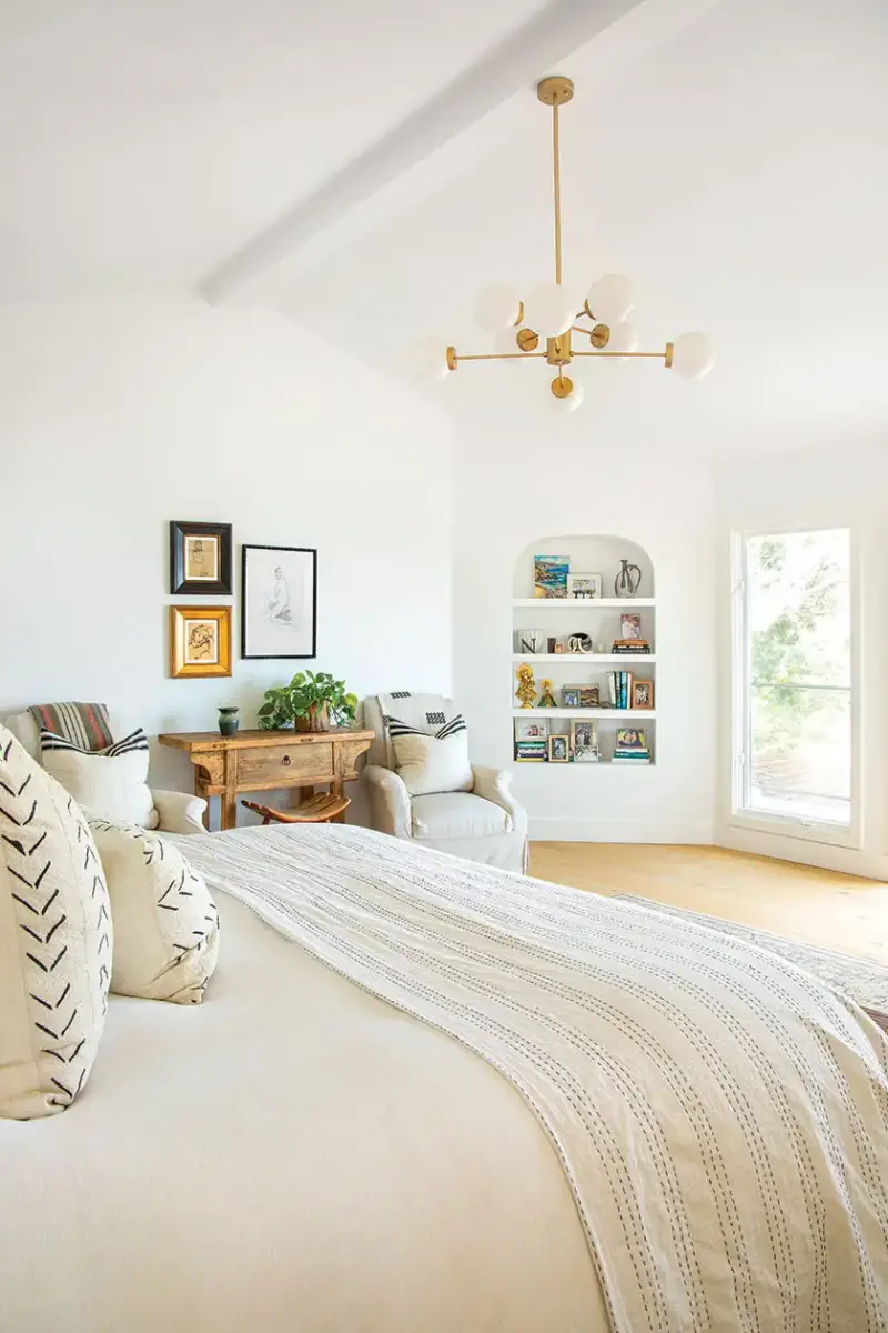 master bedroom with modern chandelier and curved nook bookshelf