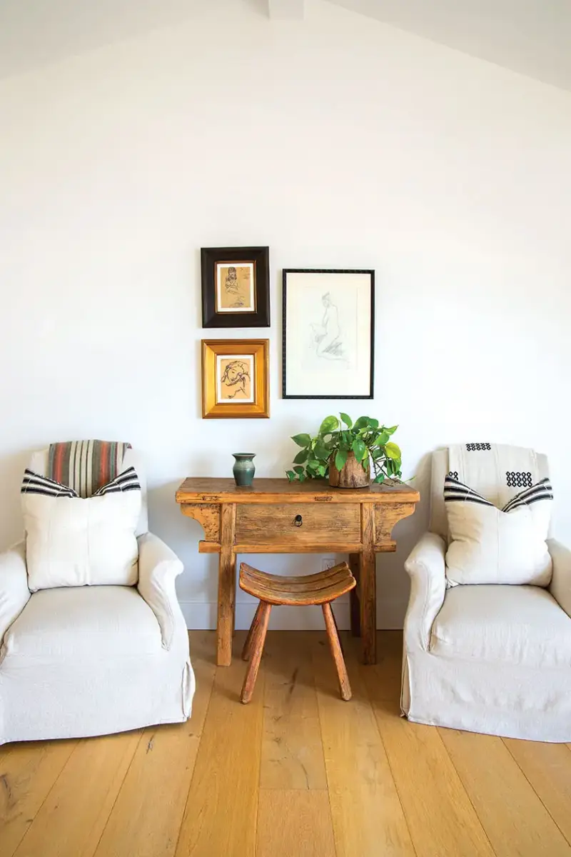 seating area with white arm chairs in primary bedroom