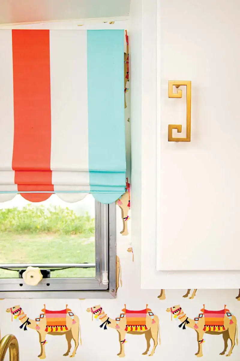 camel wallpaper, striped curtains and Greek key cabinet pulls in colorful camper