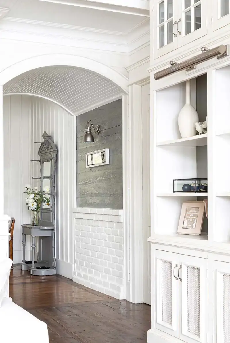 archway leading between rooms in lakeside cottage farmhouse