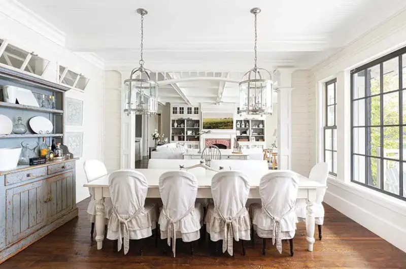 slipcovered chairs in dining room of lakeside cottage farmhouse in Lake Muskoka Ontario