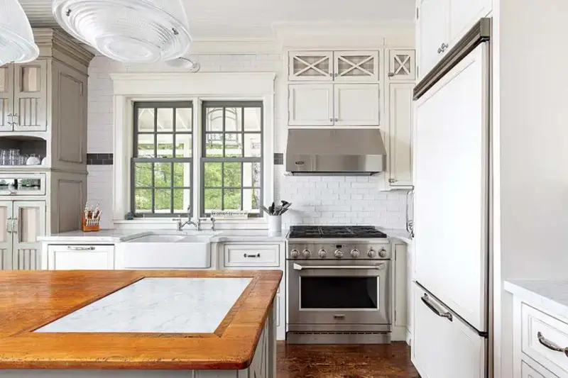 white kitchen with subway tile and farmhouse sink in lakeside cottage farmhouse