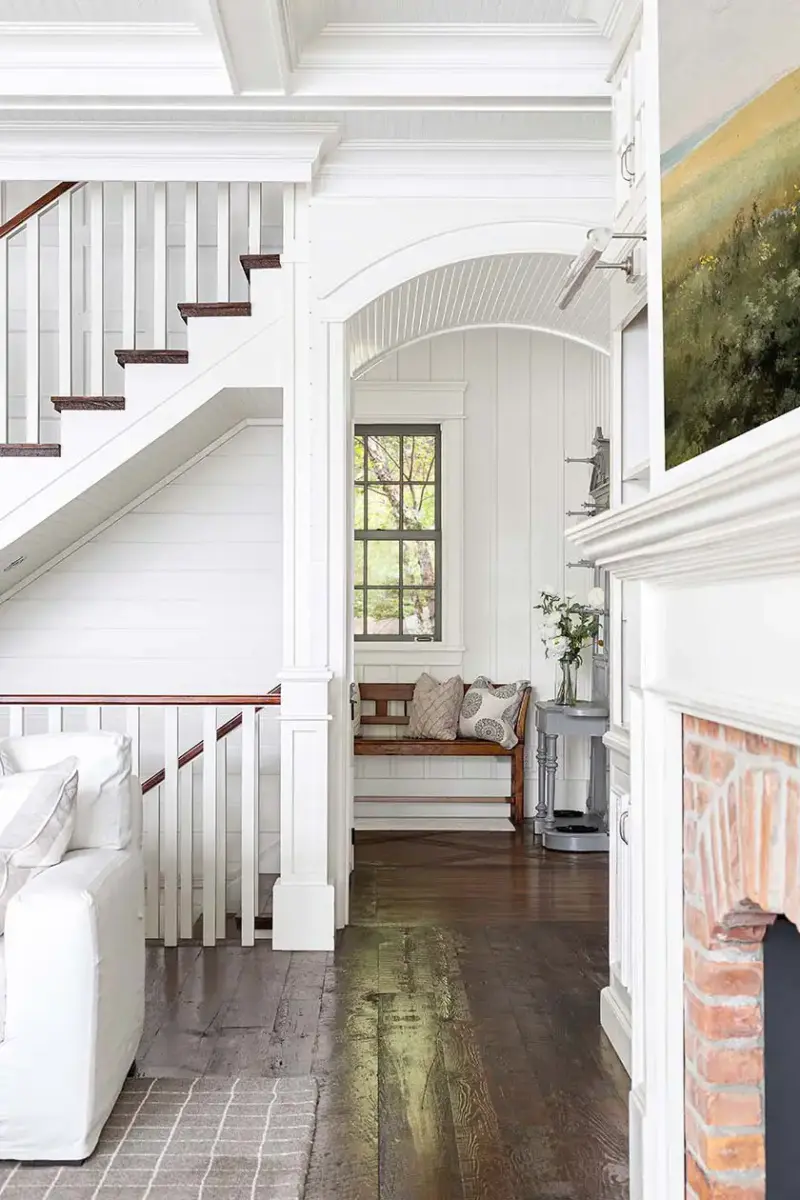 aged hemlock floors and archway leading from living room in lakeside cottage