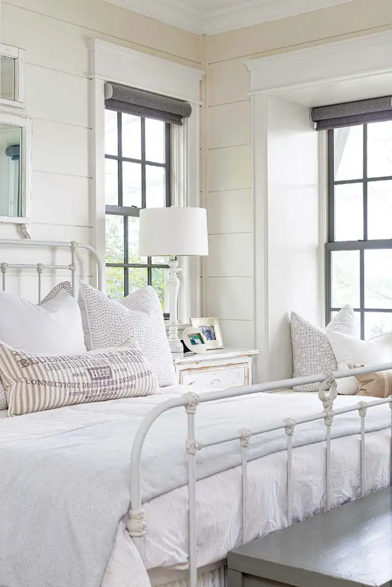 white metal bedframe with wide shiplap walls