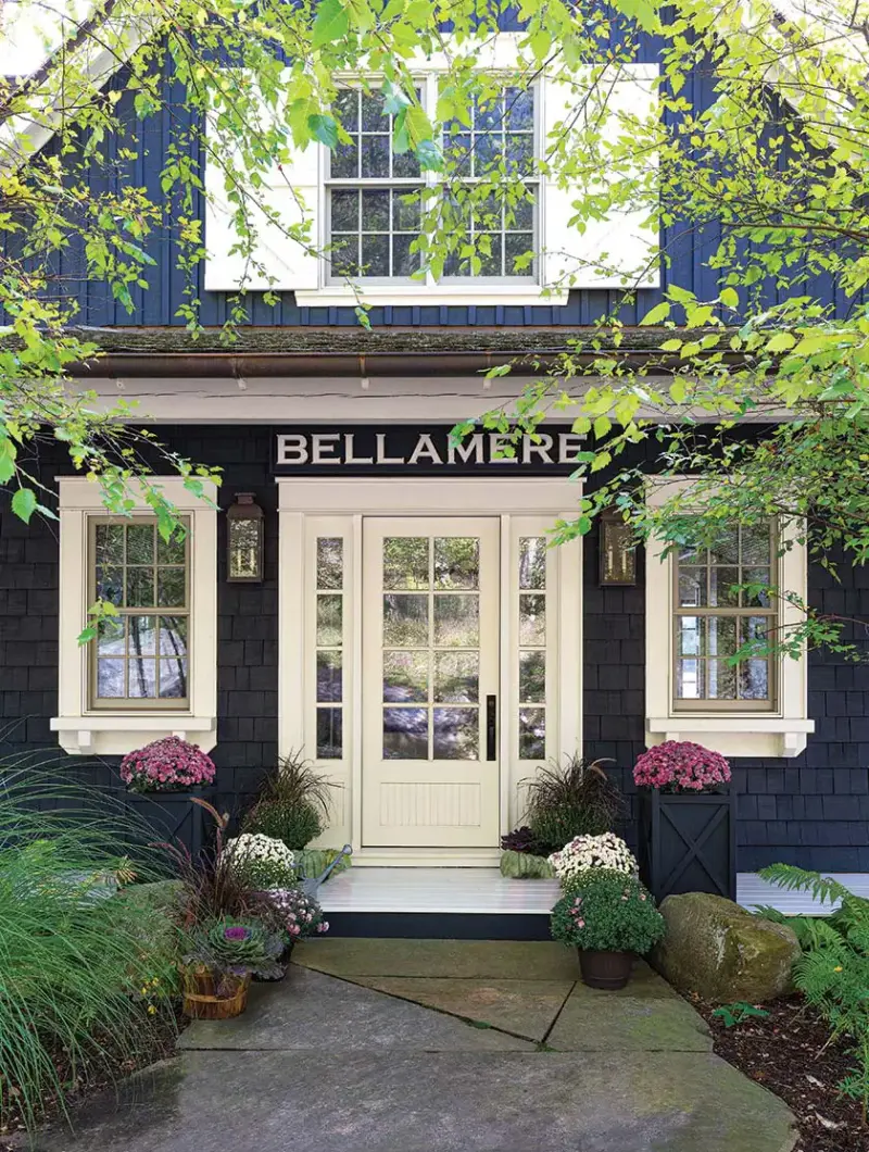 front entrance with high contrast dark gray siding with white trim and front door