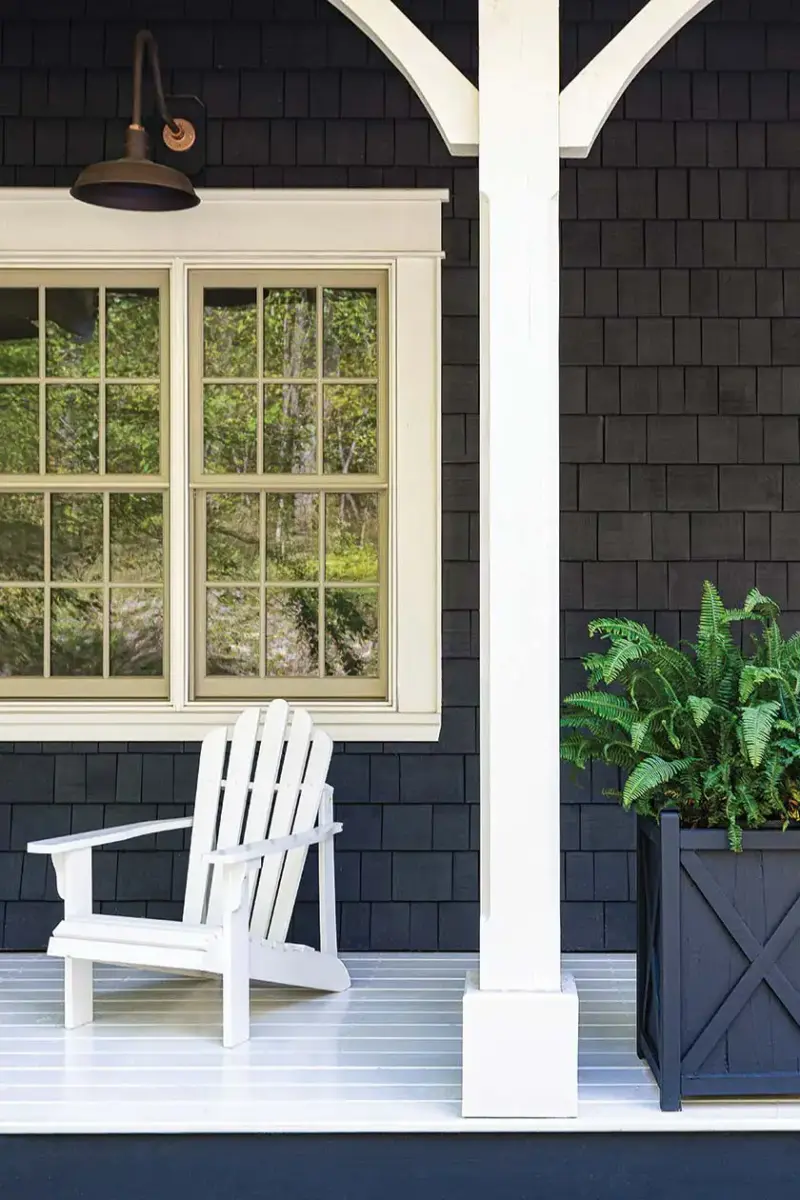 exterior patio with dark gray shingle siding white window trim, floor and support