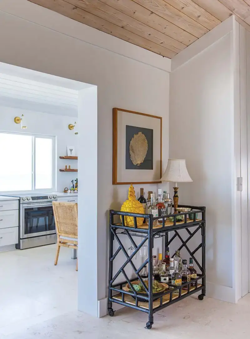 bar cart with view to the kitchen in renovated Florida home