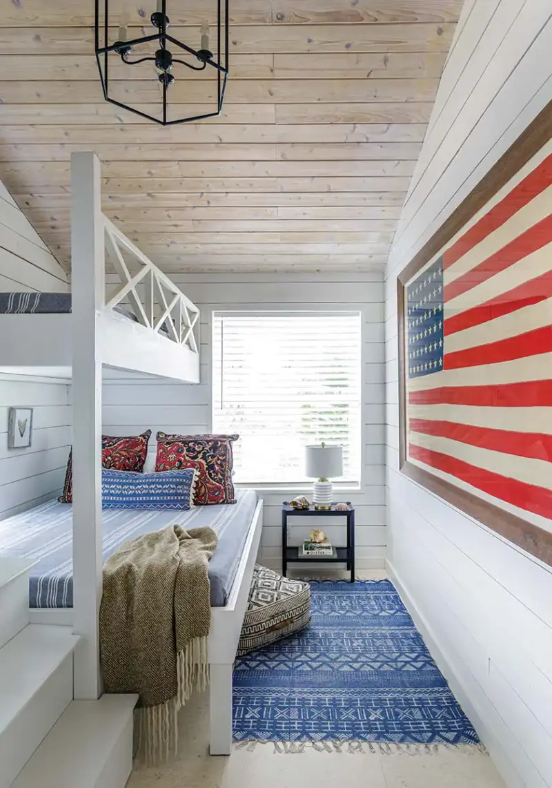 shiplap walls, bunk beds and large framed US flag in renovated Florida beach bungalow