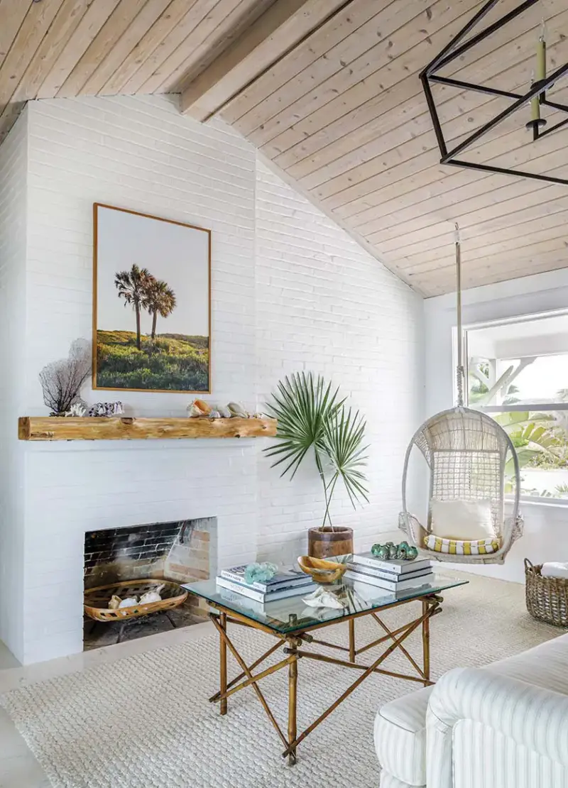 hanging chair, fireplace and cane coffee table in Florida beach bungalow