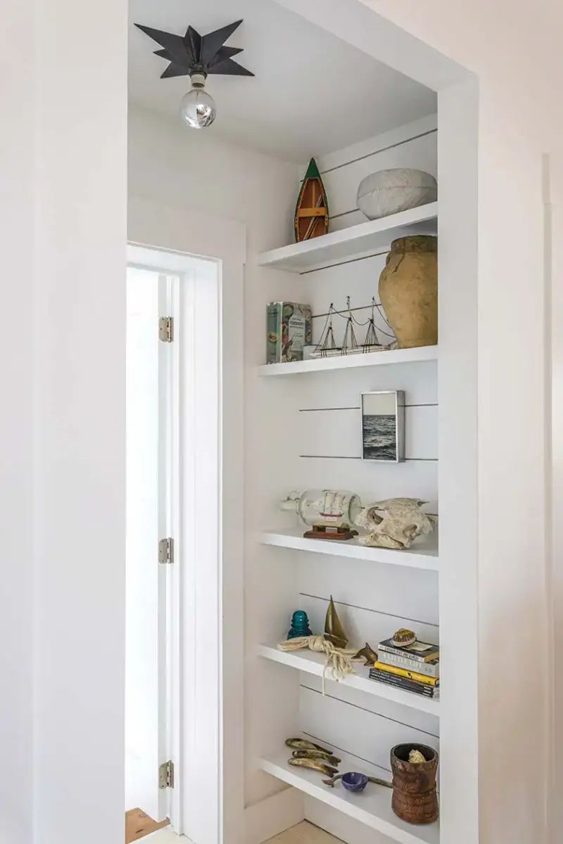 exposed shelves with miniature sail boats and ships