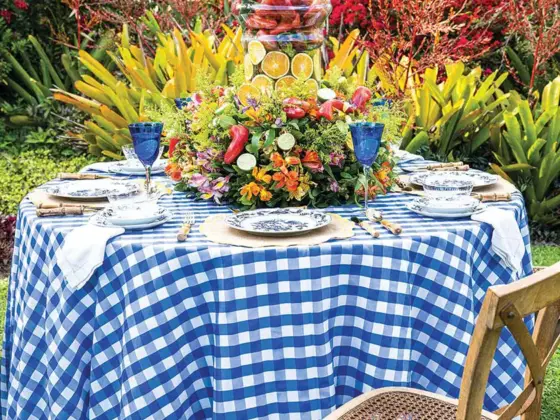 al fresco tablescape with blue and white gingham cloth and overflowing edible centerpiece