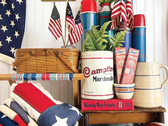 Fourth of July vignette with vintage thermoses small flags and white and blue kitchenalia