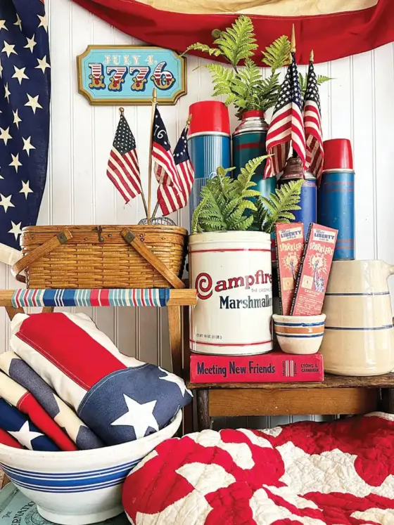 Fourth of July vignette with vintage thermoses small flags and white and blue kitchenalia