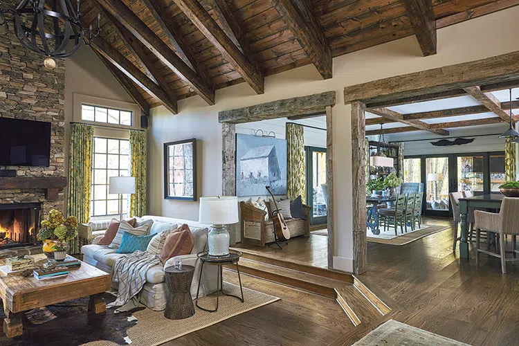 living room with high wooden ceiling, brick fireplace surround and cozy seating