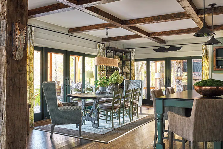 dining room with deck access overlooking trees in rustic Craftsman cottage