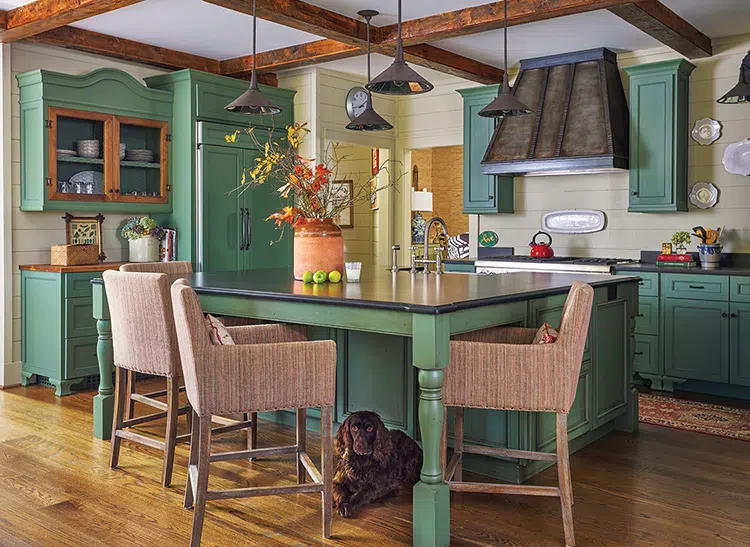 kitchen with green wooden cabinetry and large island with room for seating