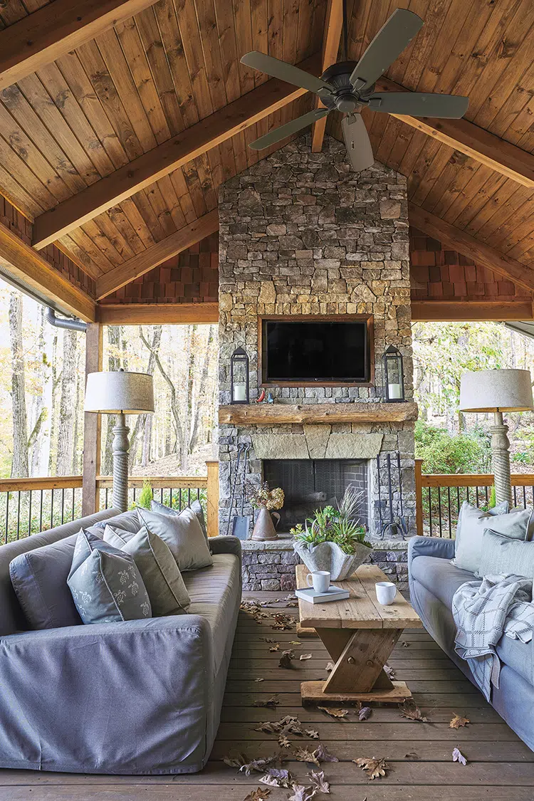 covered seating area with fireplace in rustic Craftsman cottage in Georgia