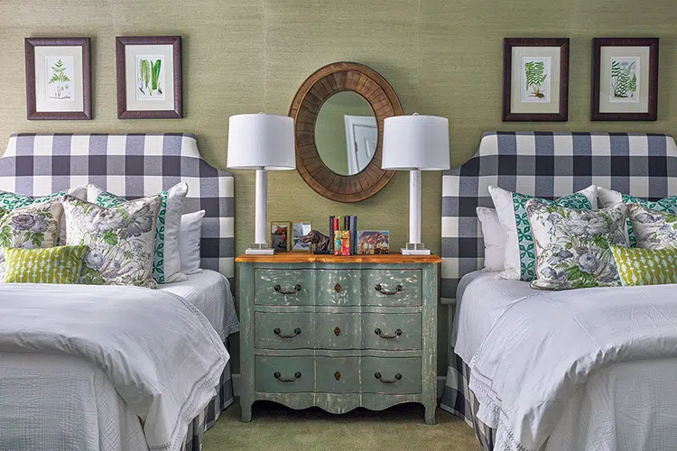 guest room with two queen beds and green grasscloth wallpaper