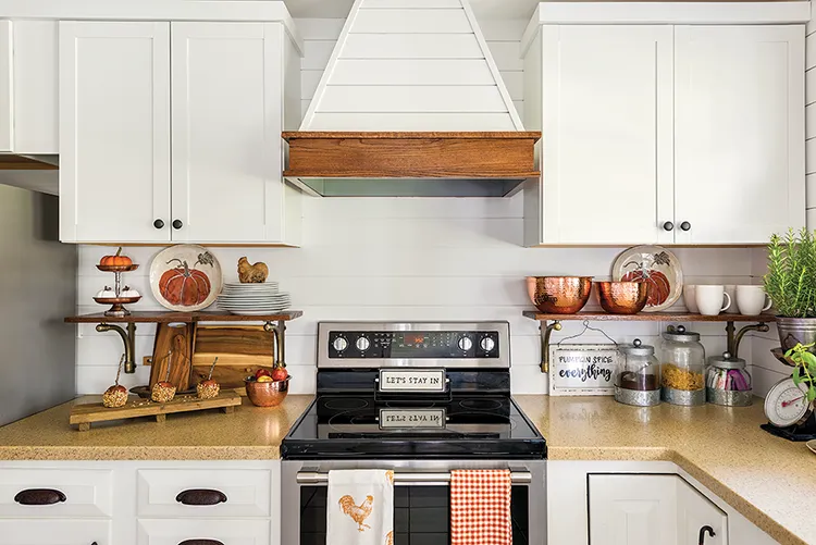 kitchen decorated for fall with pumpkin plates and homemade caramel apples