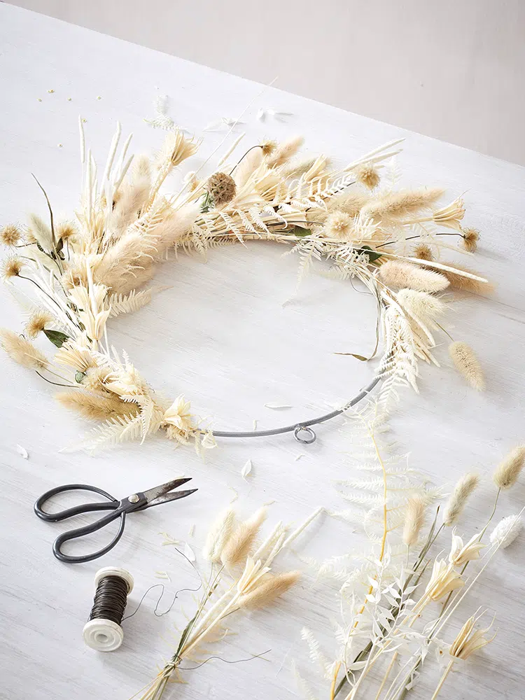 metal wreath with dried grasses and leaves