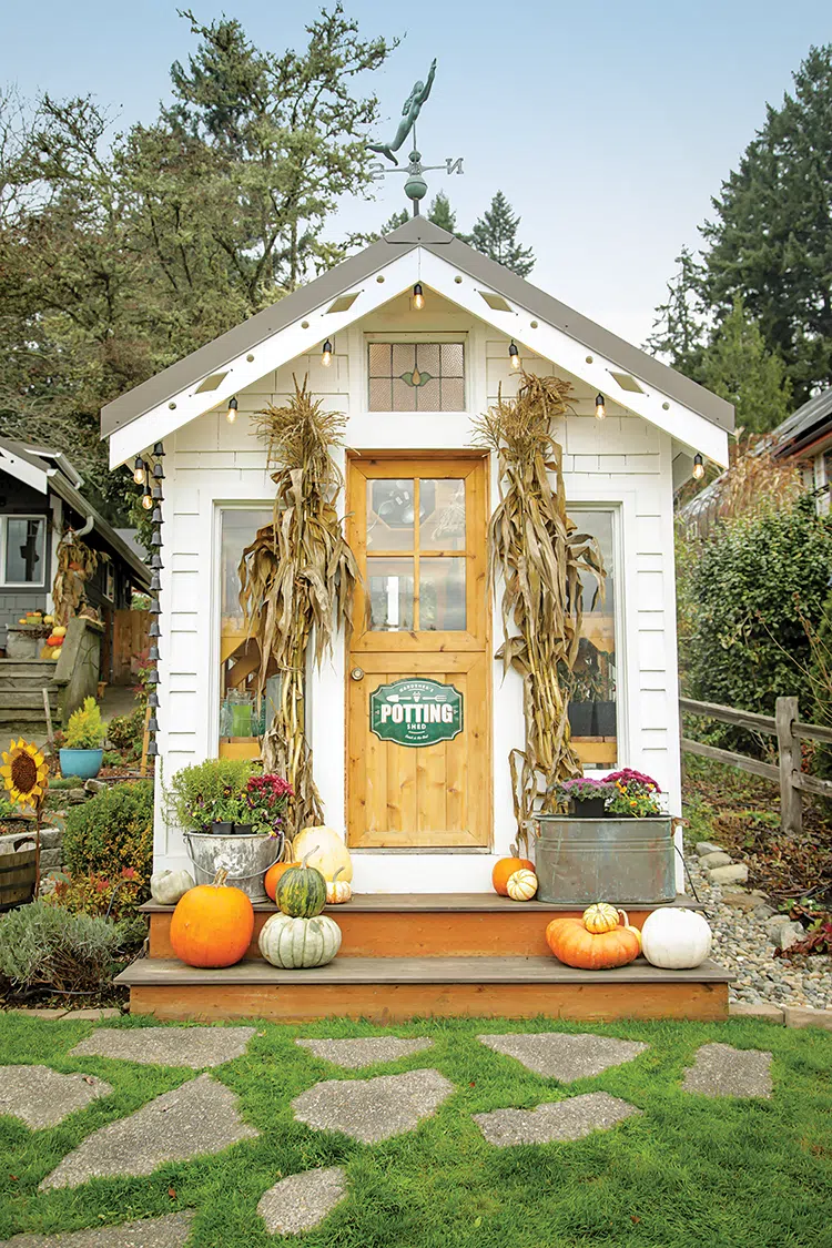 potting shed with decorative pumpkins and cornstalks