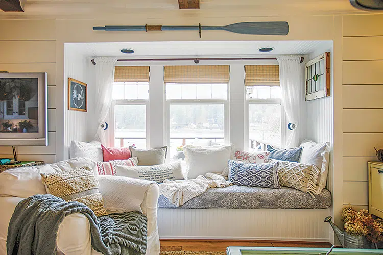 bench seating with a view and colorful cushions in cottage on Puget Sound