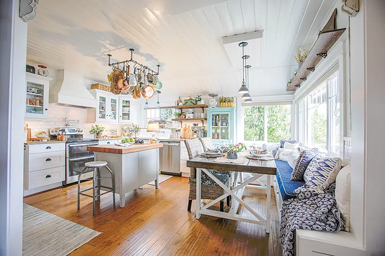 kitchen with built-in bench seating island and turquoise hutch