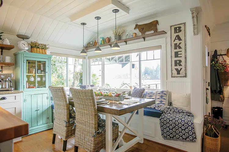 view of Puget Sound from the dining room with blue and white cushions on bench seating