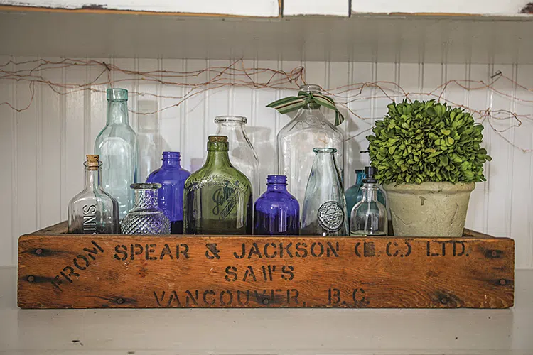 collection of vintage bottles in vintage wooden crate