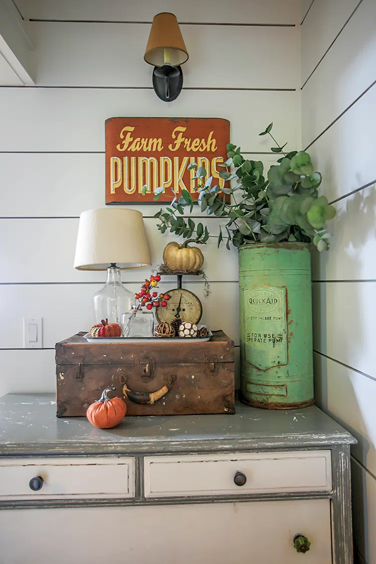 eucalyptus leaves in vintage tin and fall vignette with vintage suitcase and kitchen scale with fabric pumpkins