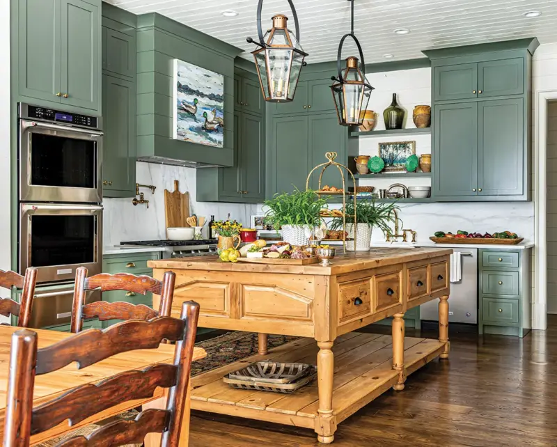 green painted cabinetry and pine island in unique home on Georgia farm