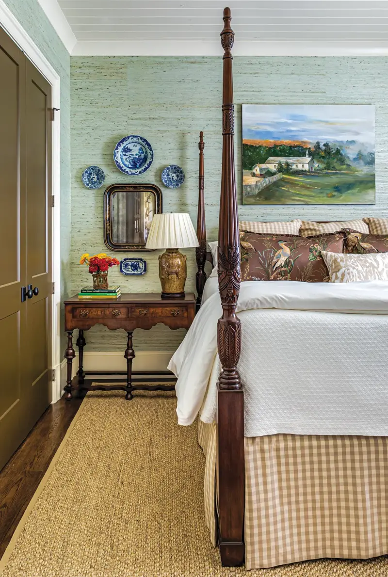 four poster bed with soft green grasscloth wallpaper in unique home on a Georgia farm