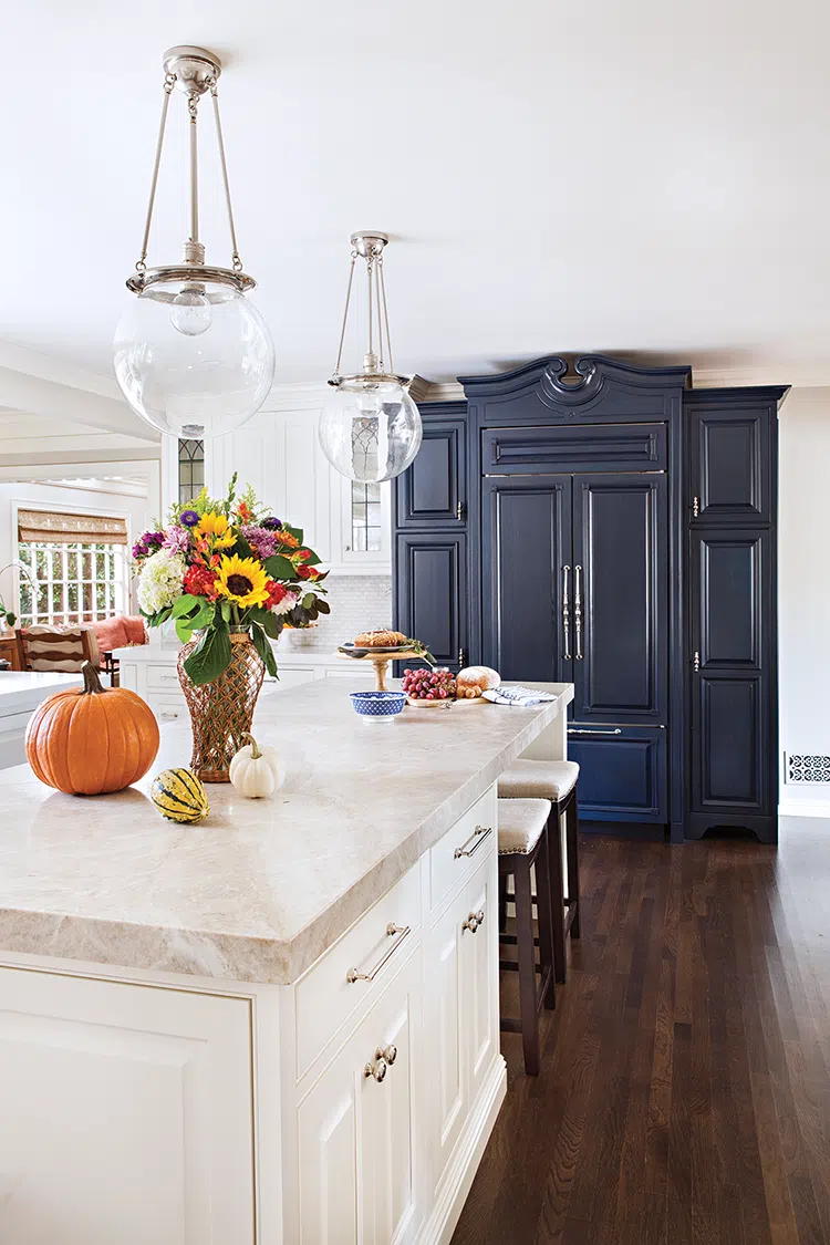 refrigerator built into custom black cabinet and long island with built-in storage and counter dining space