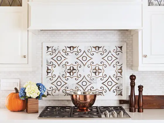 traditional tile backsplash and white kitchen cabinets in renovated La Jolla kitchen