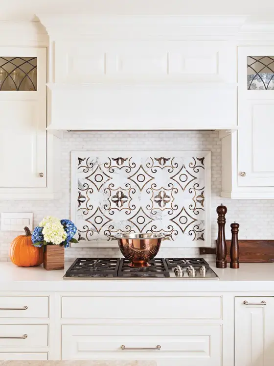 traditional tile backsplash and white kitchen cabinets in renovated La Jolla kitchen