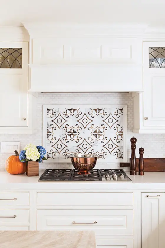 traditional tile backsplash and white kitchen cabinets in renovated La Jolla kitchen