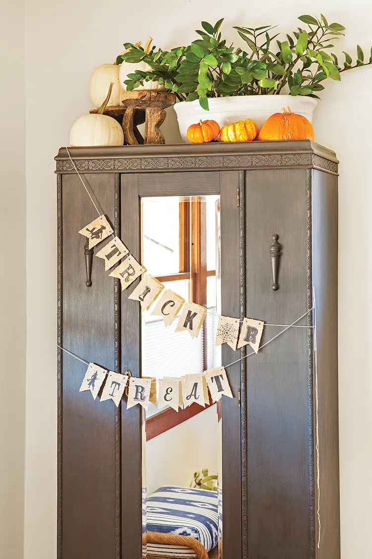 trick or treat pennants on entryway wardrobe