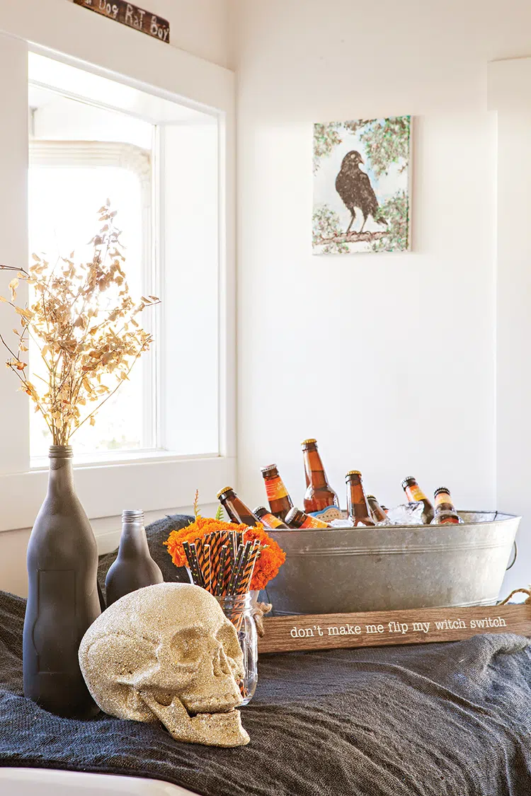 fake skull sits next to bucket of beer ready for spooky and sophisticated Halloween dinner party