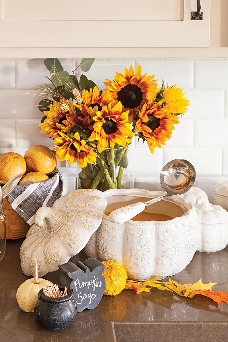 pumpkin shaped bowl with pumpkin soup ready for spooky and sophisticated Halloween dinner party