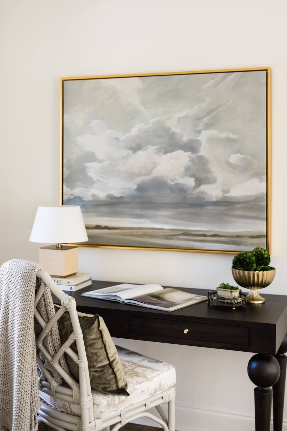 desk with chinoiserie chair and landscape painting with stormy sky