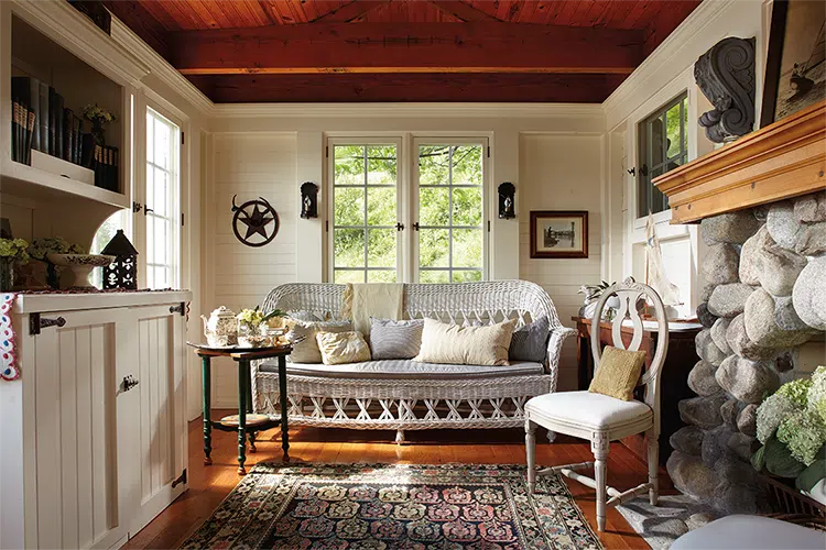 boathouse with white shiplap walls and stone fireplace