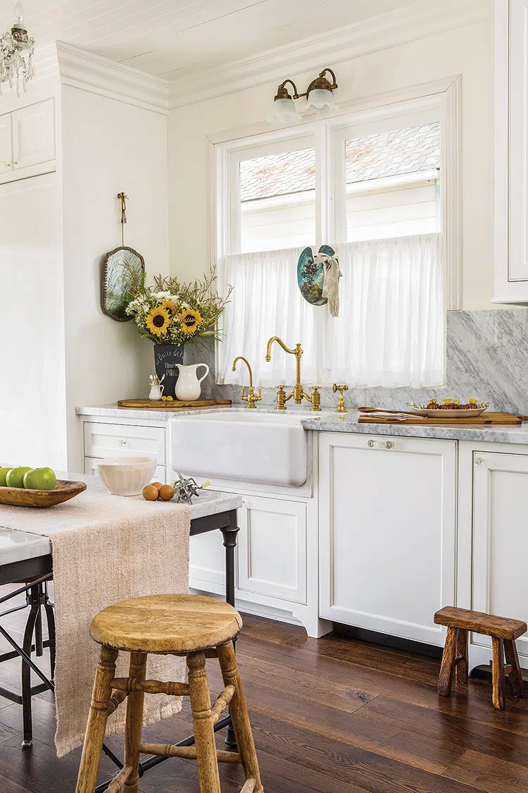 kitchen in Victorian home decorated with fall flowers and vintage furniture