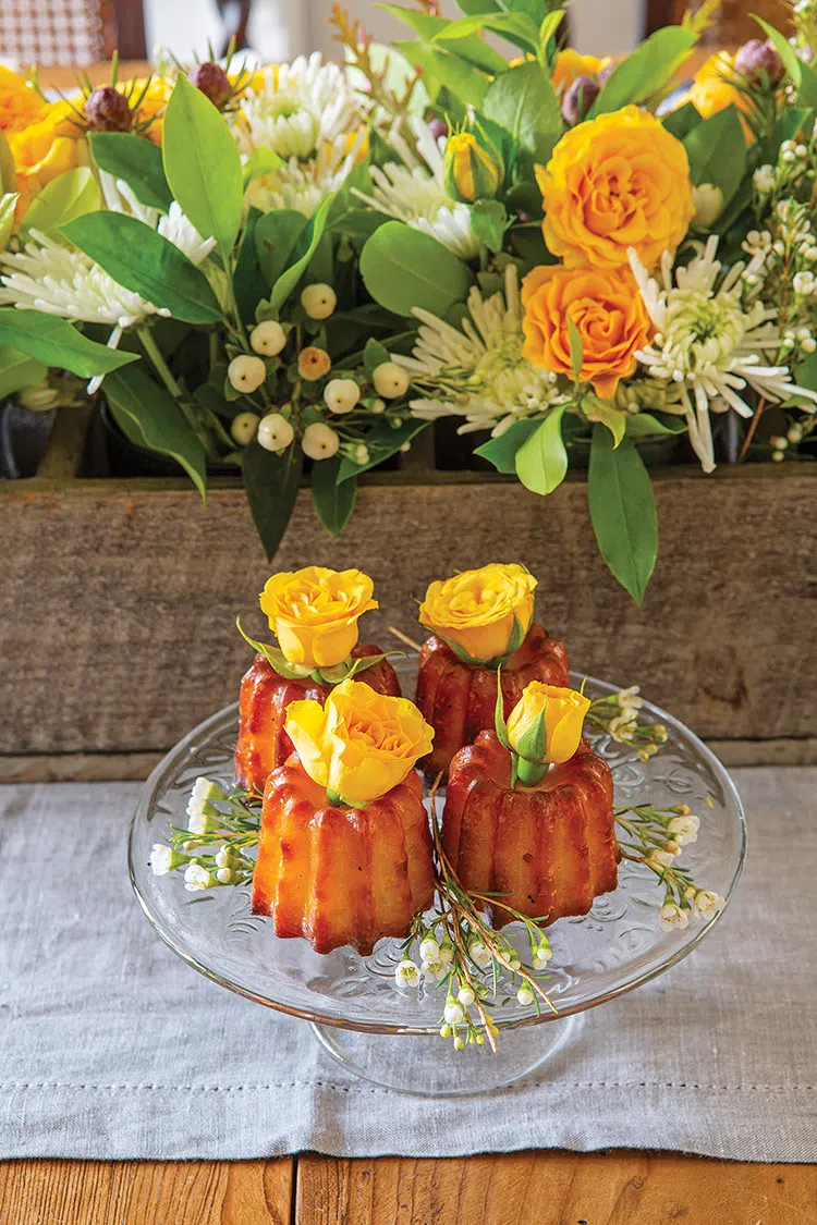 fall home with fresh yellow roses decorating table and dessert