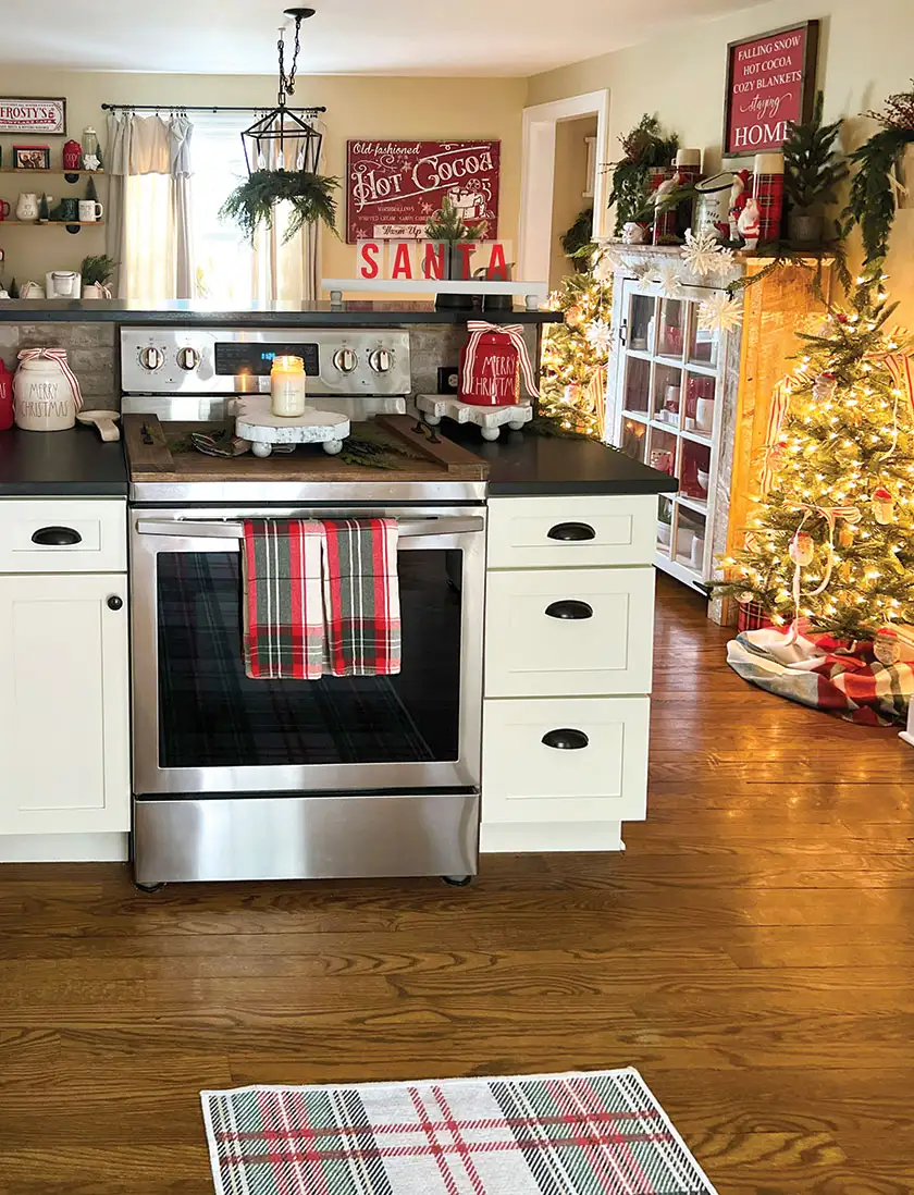 kitchen with Merry Christmas cookie jars and fresh greenery in chadelier