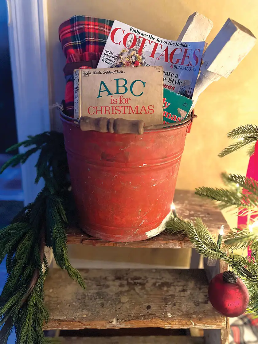 red galvanized tin bucket with Christmas reading in cozy little Christmas home