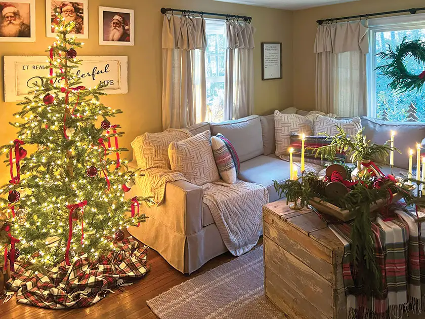 cozy little Christmas home living room with taper candles and Christmas tree with red bows