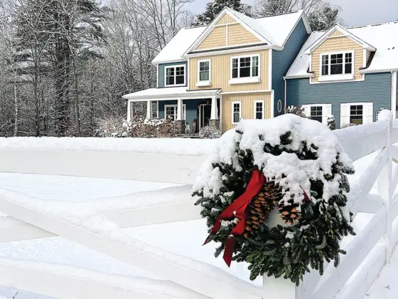 wreath on the corner of fence with view to exterior of Pantry Hill dusted in snow